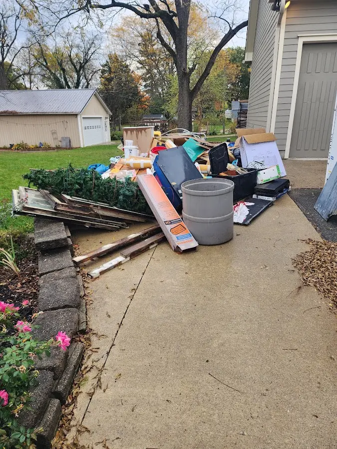 Dumpster being loaded with debris for 12 Yard Dumpster Rental in Keller